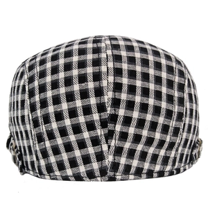 Detail view of the black and white checkered pattern on a retro cotton beret hat