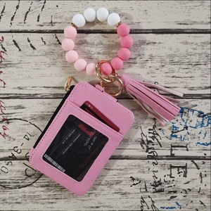 Detail of pink leather card wallet set with gradient silicone beads and tassel charm