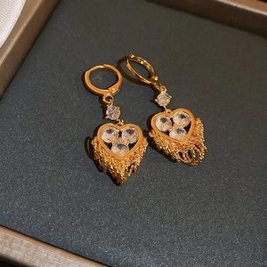 Detailed view of luxury gold-plated heart earrings featuring sparkling zircon inlay