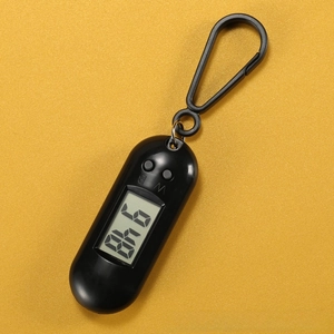 Detail of black digital mini pocket watch with LCD screen showing numbers and key hooks