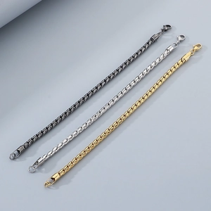 Detailed view of woven twisted link bracelets in silver, gold, and black stainless steel
