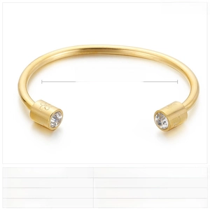 Detail of gold stainless steel cuff bangle showing rhinestone inlay and engraved flower motifs