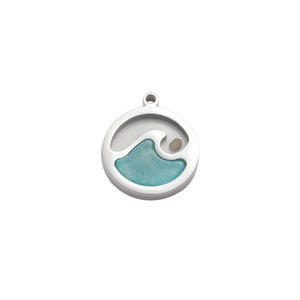 Macro detail of round stainless steel pendant featuring blue wave inlay and small bead