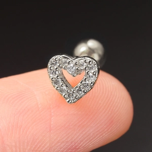 Macro shot of silver heart stud earring with clear pavé zircon and screw back closure