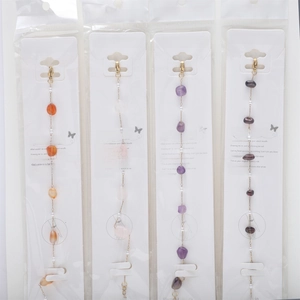 Detail of colorful natural stones and pearls on 18K gold plated stainless steel chains