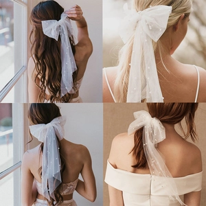 Elegant white mesh bow bridal veil with scattered pearls and long trailing ribbons