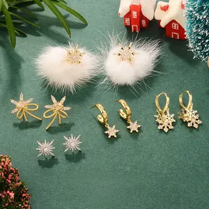 Detail of Christmas snowflake earrings with white faux fur balls and rhinestone accents