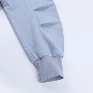 Macro shot of light blue ribbed cuffs and textured composite fabric on casual jacket