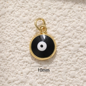 Macro detail of 10mm round gold-plated Evil Eye pendant with black and white enamel