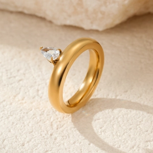 Close-up of a 18k gold-plated stainless steel ring with a pear-shaped gemstone detail
