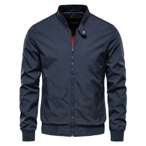 Detail of navy blue pilot jacket with stand-up collar and contrasting red lining interior