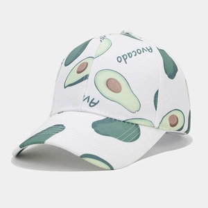 Close-up of white cotton baseball cap featuring green avocado print and breathable eyelets