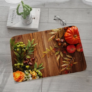 Detail of autumn harvest flannel mat with pumpkin and wood grain on grey floor