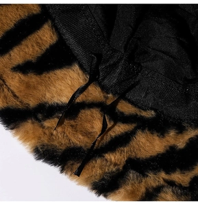Macro shot of zebra print faux fur texture with black inner lining and adjustable drawstring