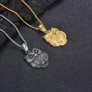 Close-up of owl pendants in gold and silver finish with detailed feather textures