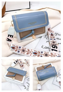 Detail view of tri-color crossbody bag with golden embroidery and wide ethnic strap