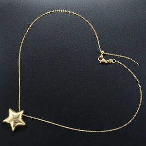 Detailed view of a gold star pendant on a heart-shaped chain with adjustable slider clasp