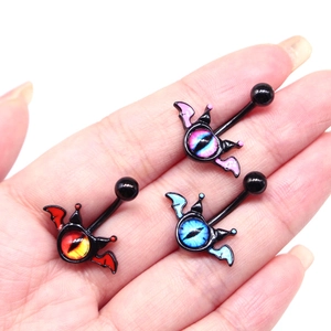 Macro view of devil eye belly rings in pink, red and blue held in palm with metal shafts