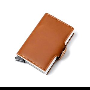 Detail of brown PU leather card holder showing tidy stitching and metal popup frame