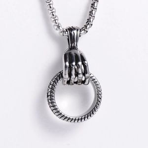 Détail d'un pendentif main de squelette punk avec un anneau en métal argenté