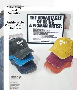 Detailed close-up showing washed cotton baseball caps in multiple colors on white surface