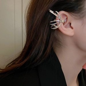 Detail of silver multilayered ear cuff with zircon butterfly tassel for women without piercing