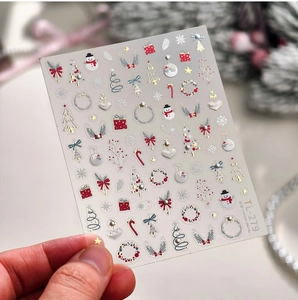 Detail of Christmas nail art stickers with 3D gold embossed trees and stars TL279