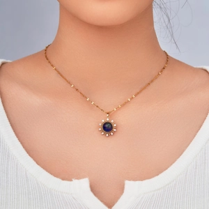 Minimalist gold necklace with a sunflower-shaped pendant and dark blue stone for women