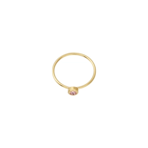 Detailed view of minimalist gold ring with round pink birthstone in bezel setting