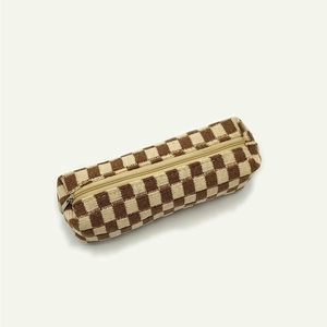 Detailed view of checkered knit stationery bag with smooth zipper and soft woven texture