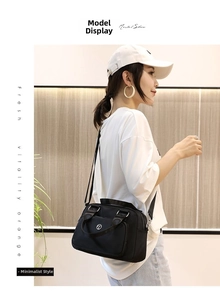 Fashionable black nylon crossbody bag worn by a model in a casual indoor setting