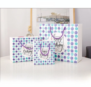 Three sizes of watercolor polka dot Happy Birthday paper gift bags with purple handles