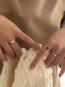 925 Sterling silver gold rings set with green and white gems on model's hand
