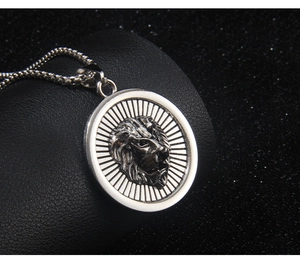 Close-up of silver stainless steel necklace with a 3D lion head pendant on black leather