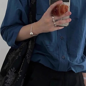 Sparkling silver ball hair tie and fashion accessories styled with a dark blue shirt