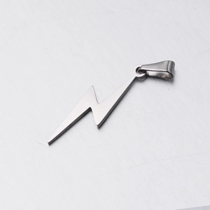 Close-up of polished silver lightning bolt pendant with jump ring in stainless steel