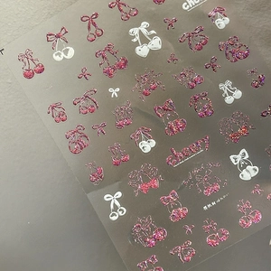 Macro shot of Cherry Sweet ta-385 nail stickers with pink glitter bows and cherry patterns