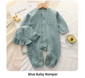 Blue muslin cotton baby romper with matching ruffled hat on a minimalist setup