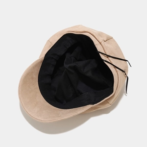 Beige faux suede newsboy cap with adjustable inner drawstring and premium black lining