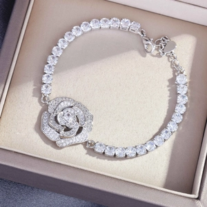Detailed close-up of a silver floral bracelet with cubic zirconia in a jewelry box
