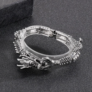 Macro detail of retro dragon head clasp and scale texture on stainless steel bracelet