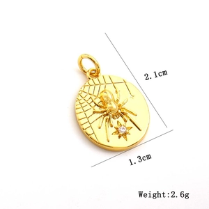 Detail of golden spider web pendant with zircon showing 2.1cm height and 1.3cm width