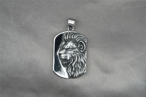 Detailed macro shot of vintage stainless steel military tag pendant with embossed lion head