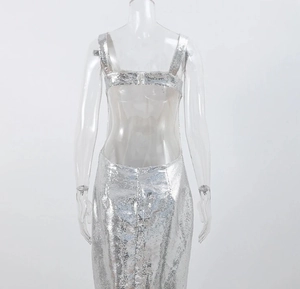 Detail of silver sequin evening dress showing deep backless design and thin straps