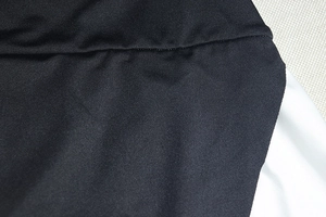 Detail shot of the black and white fabric stitching on a high neck A-line dress