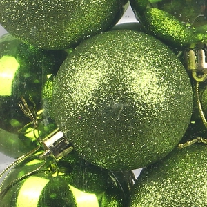 Green Christmas ornaments with glitter and mirror finish, featuring golden caps and strings