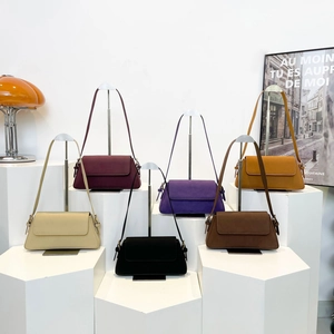 Collection of retro underarm bags in six autumn colors displayed with modern props
