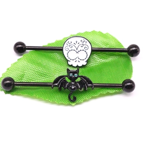 Industrial barbell jewelry set featuring black surgical steel bars with skull and bat cat charms