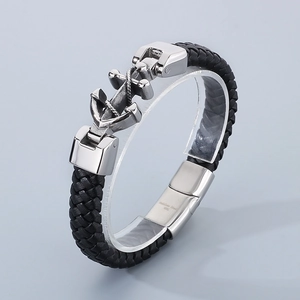 Detail of silver stainless steel anchor clasp on black braided leather men's bracelet