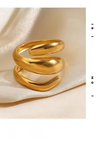 Macro view of gold spiral thick band ring with polished metallic finish on satin